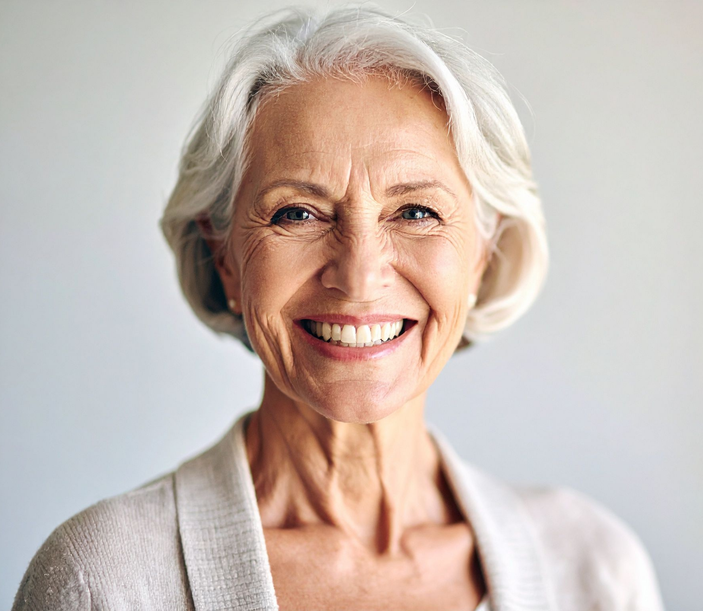 Confident patient smiling after restorative dental implant treatment